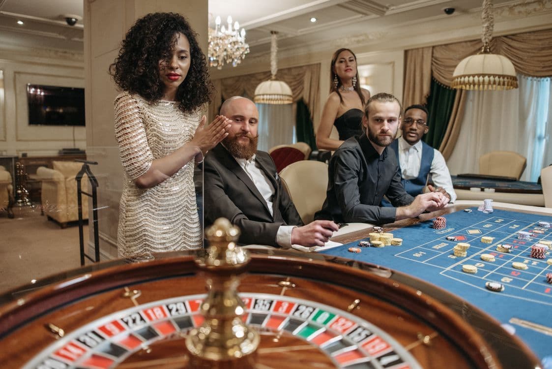 Roulette table and players in a casino, illustrating the casino segment of iGaming